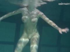 KiloPantyhose presents: Naked brunette with big tits swims solo